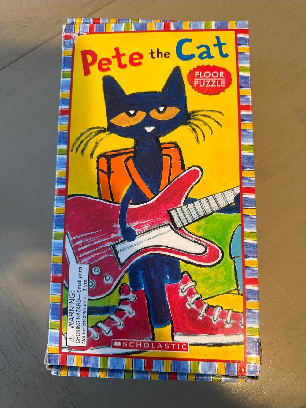 Scholastic Pete the Cat Puzzle with Yellow Background and Pink Guitar